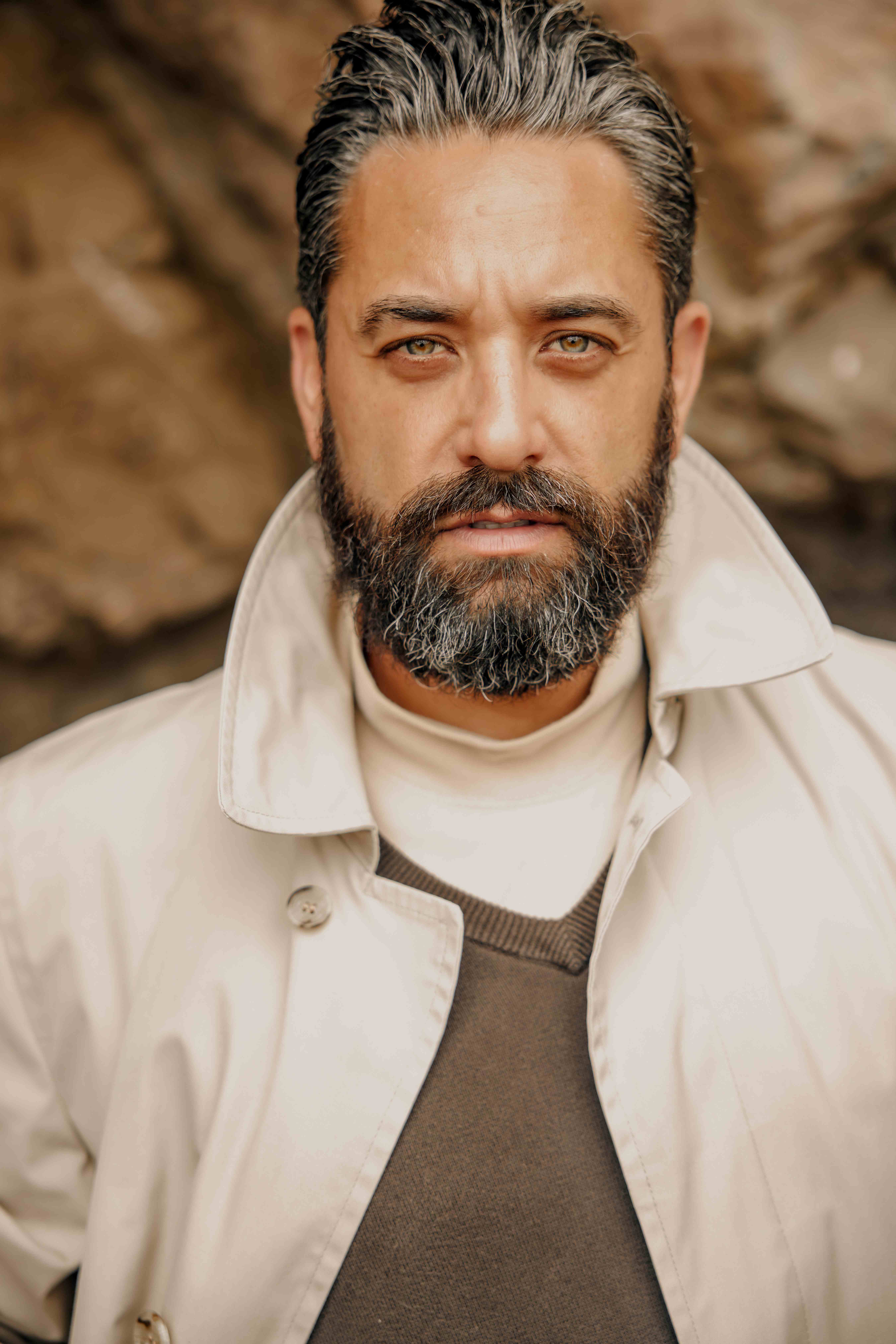 Professional male model with beard wearing elegant green suit - lifestyle fashion photography